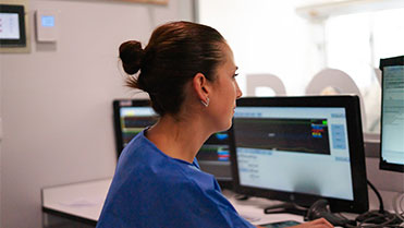 Nurse on the computer looking at intelligence dashboard