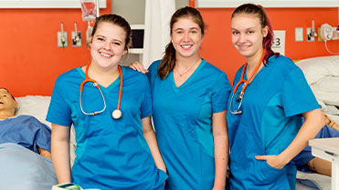 3 student nurses in training setting