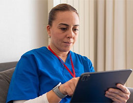 Nurse reading on her tablet