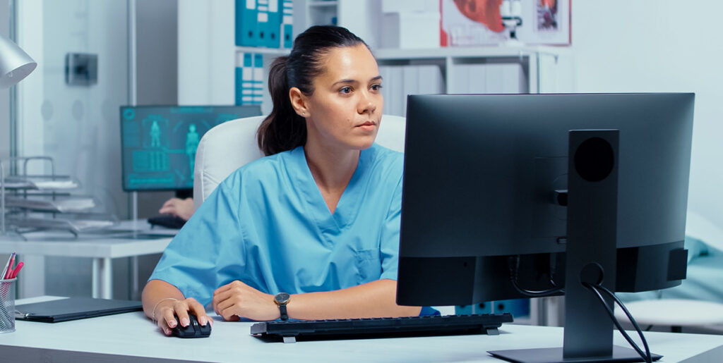 Nurse using a computer in a high tech environment