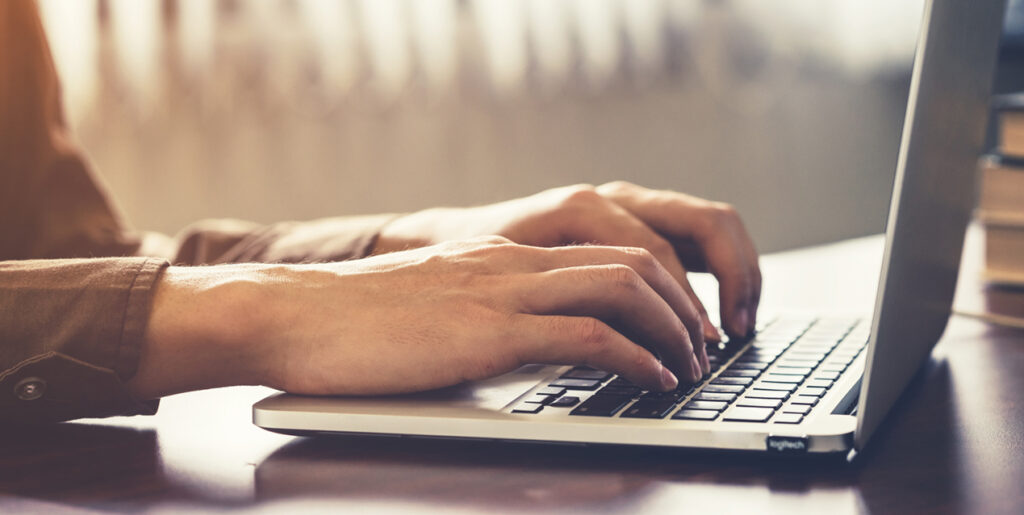 Person typing on a laptop