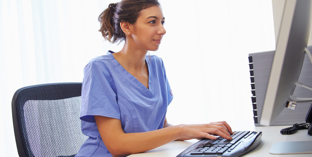 Nurse typing on computer